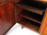 a wooden cabinet with a drawer inside of it