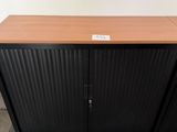 a close up of a wooden cabinet with a metal door