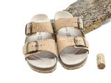 a pair of corks and a pair of sandals on the ground