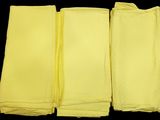 four yellow napkins on a black background with a black background