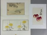 three framed chinese paintings of flowers and birds on a table