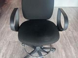 a black office chair that is sitting on a wooden floor