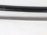 a close up of a sword on a white surface
