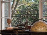 a large globe sitting on a table in front of a window