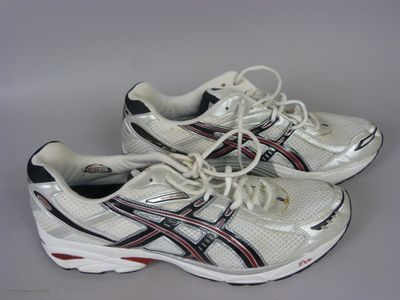 pair of white sneakers with black and red stripes on them