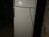 a white refrigerator with a clock on it in a dark room