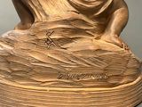 statue of a woman holding a bird in her hand on top of a wooden base
