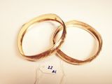 pair of gold wedding rings on white background with price tag
