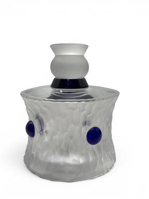 gray and blue glass jar with a white top and a black base