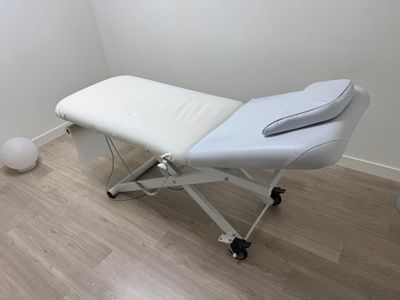 a massage table in the corner of a room