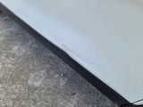 a white car that is parked on the side of the road