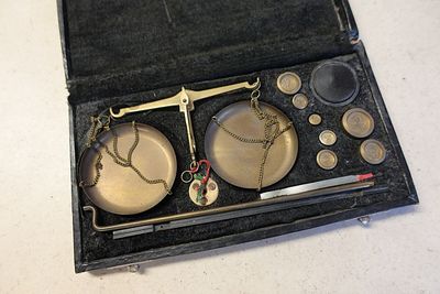 une boîte contenant une balance et une paire de ciseaux