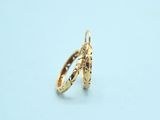two gold rings on a white surface with a light blue background