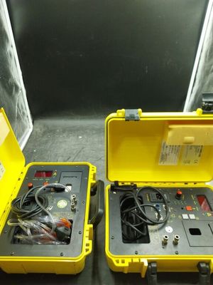 two yellow cases with wires in them on a table