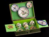 a green box with a bunch of decorative items inside of it
