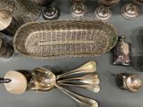 a lot of silver spoons and other silverware on a table