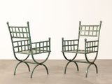 pair of green wrought iron garden chairs