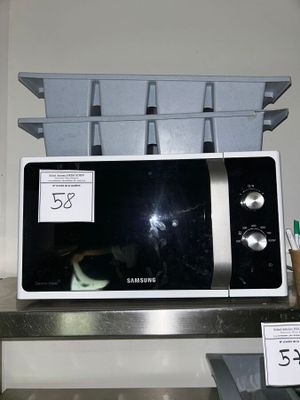 a microwave that is sitting on a shelf in the kitchen