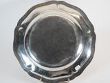 a silver plate on a table with a white background