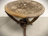 a wooden table with a decorative design on it