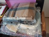 a pile of blankets sitting on top of a wooden table