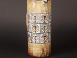a tall vase with a design on it on a table
