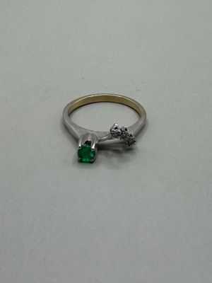 a silver ring with a green stone on it