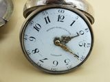 a clock that is sitting on a table next to a spoon