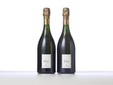 two bottles of champagne sitting on top of a table