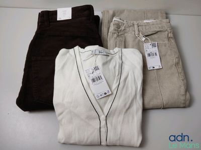 three pairs of men ' s pants are sitting on a table