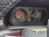 a close up of a dashboard with gauges and speedometers