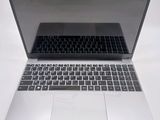 a silver laptop with a black keyboard on a white surface