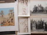 many old photos of a building on a table