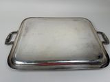 silver plated serving tray with handles and handles on a white surface