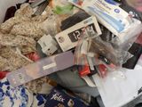 a pile of clothing and other items in a suitcase