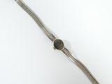 an image of a wrist watch with a black face on a white surface
