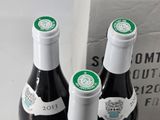 two bottles of wine sitting next to each other on a table