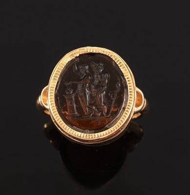 a gold ring with an image of a man and woman on a horse
