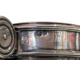 a large silver pot with a lid on a table