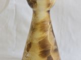 a brown and white vase sitting on a white surface