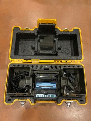 an open tool case with a battery and charger inside