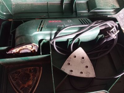 a green box with tools in it on a table