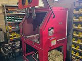 a red machine that is sitting in the middle of a room