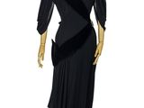 mannequin dressed in black dress on wooden stand on white background