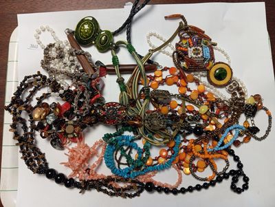un tas de perles et de colliers de toutes sortes posés sur une table
