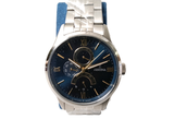 a silver and blue watch with a blue band