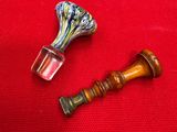two pieces of glass sitting on a red cloth