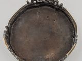 a close up of a metal object on a white surface