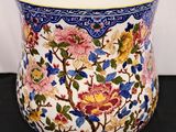 a vase with a floral design on it on a table