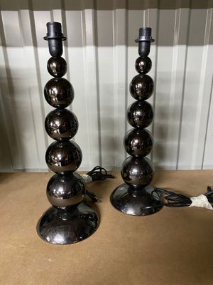 pair of chrome ball lamps on a table in a room